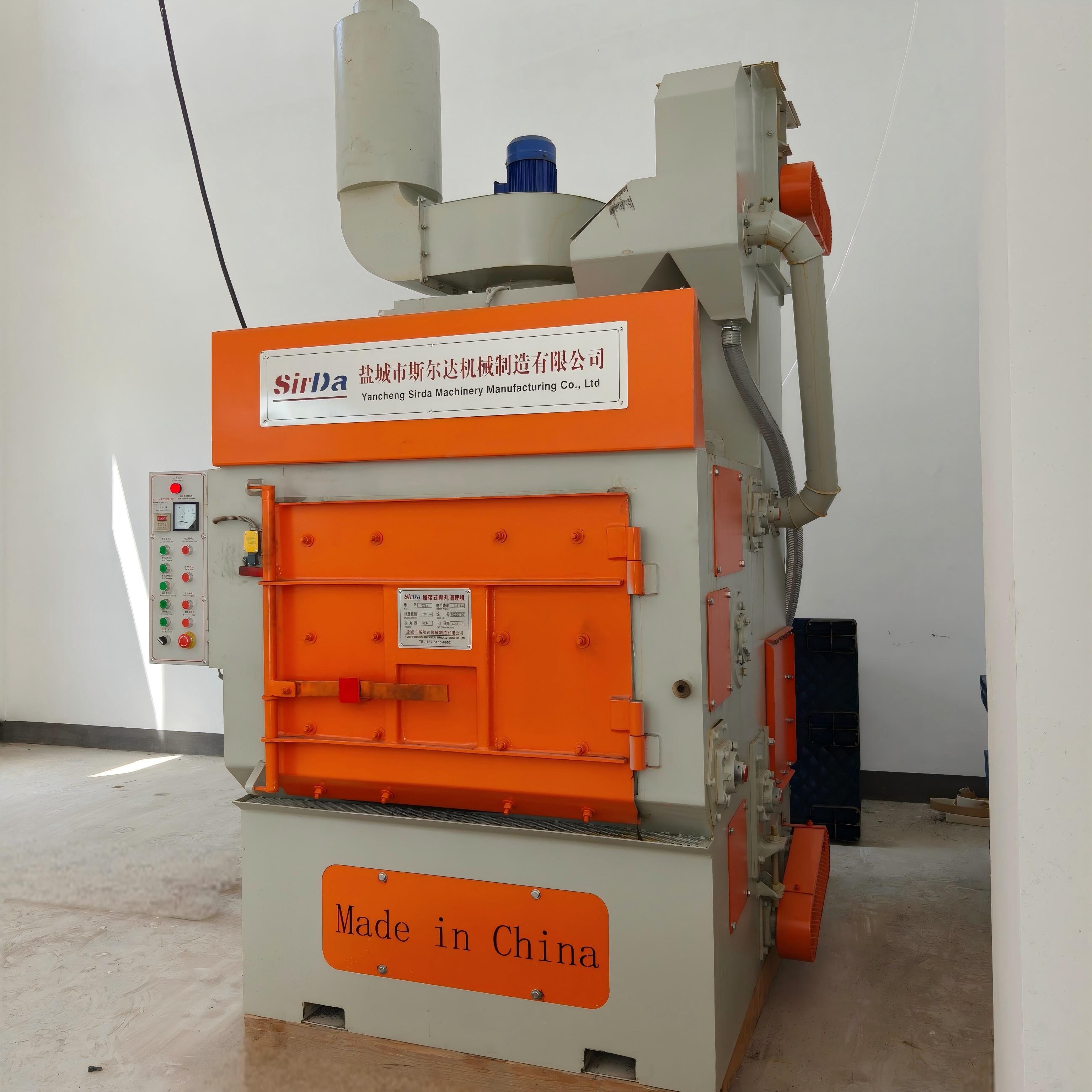 Roller conveyor blast machine feeding parts toward a galvanizing line